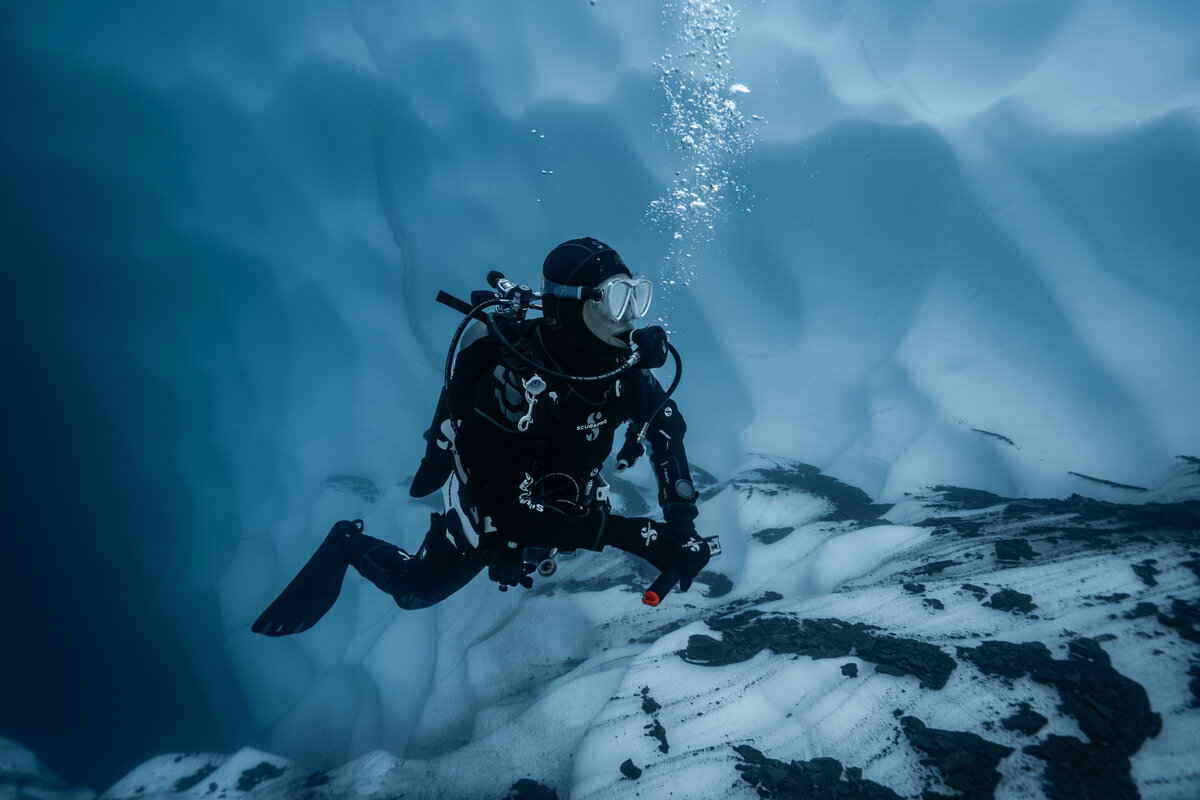 Andi Cross diving under ice in an ice cave